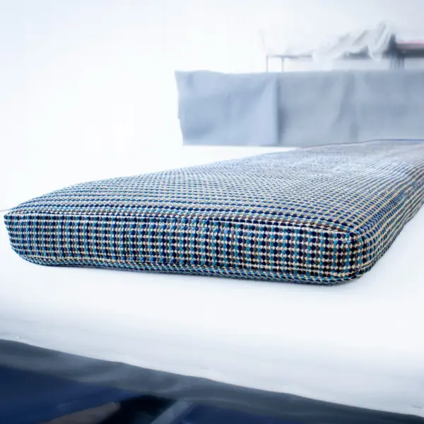 Office banquette cushion in blue tweed.