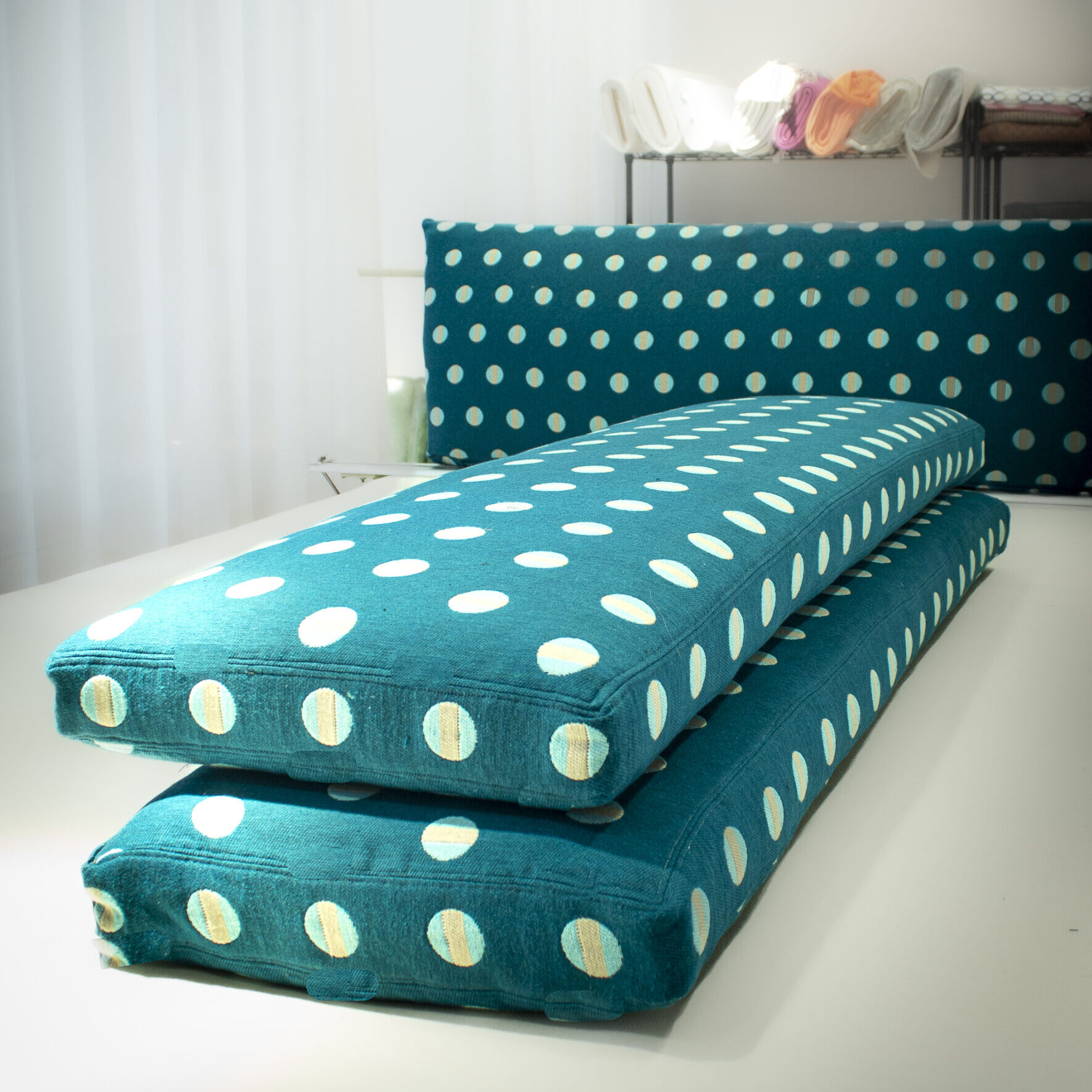 Banquette cushion set in green polkadot textile.