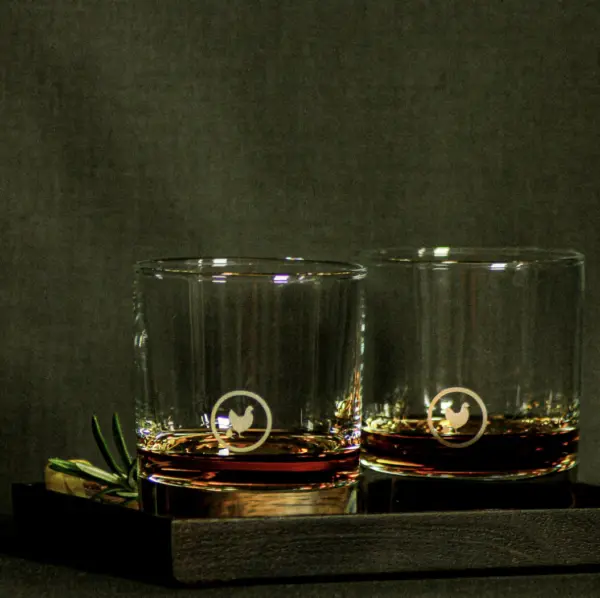 2 whiskey glasses with Sullivan Mercantile icon on front