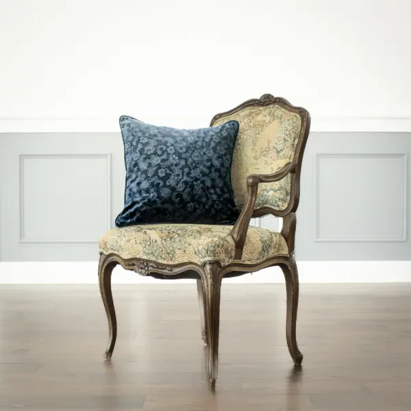 Midnight Arboreal navy blue velvet jacquard throw pillow on a chair.